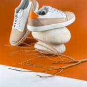 Product pair of orange and white shoes two